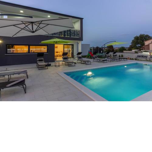 Luxury modern villa with heated pool near the beach and town center